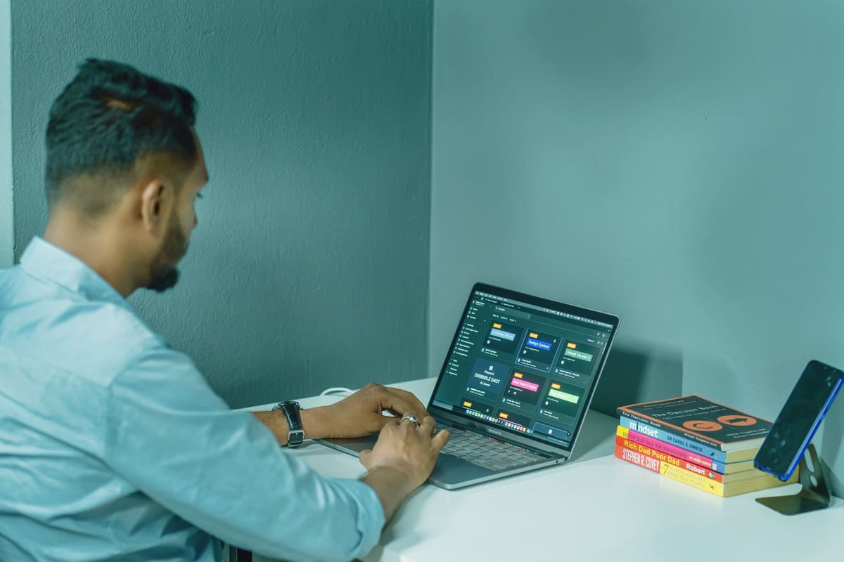 Man setting up his website and domain on a laptop in a home office